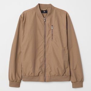 Bomber jacket with a ribbed stand-up collar and zip down the front.
